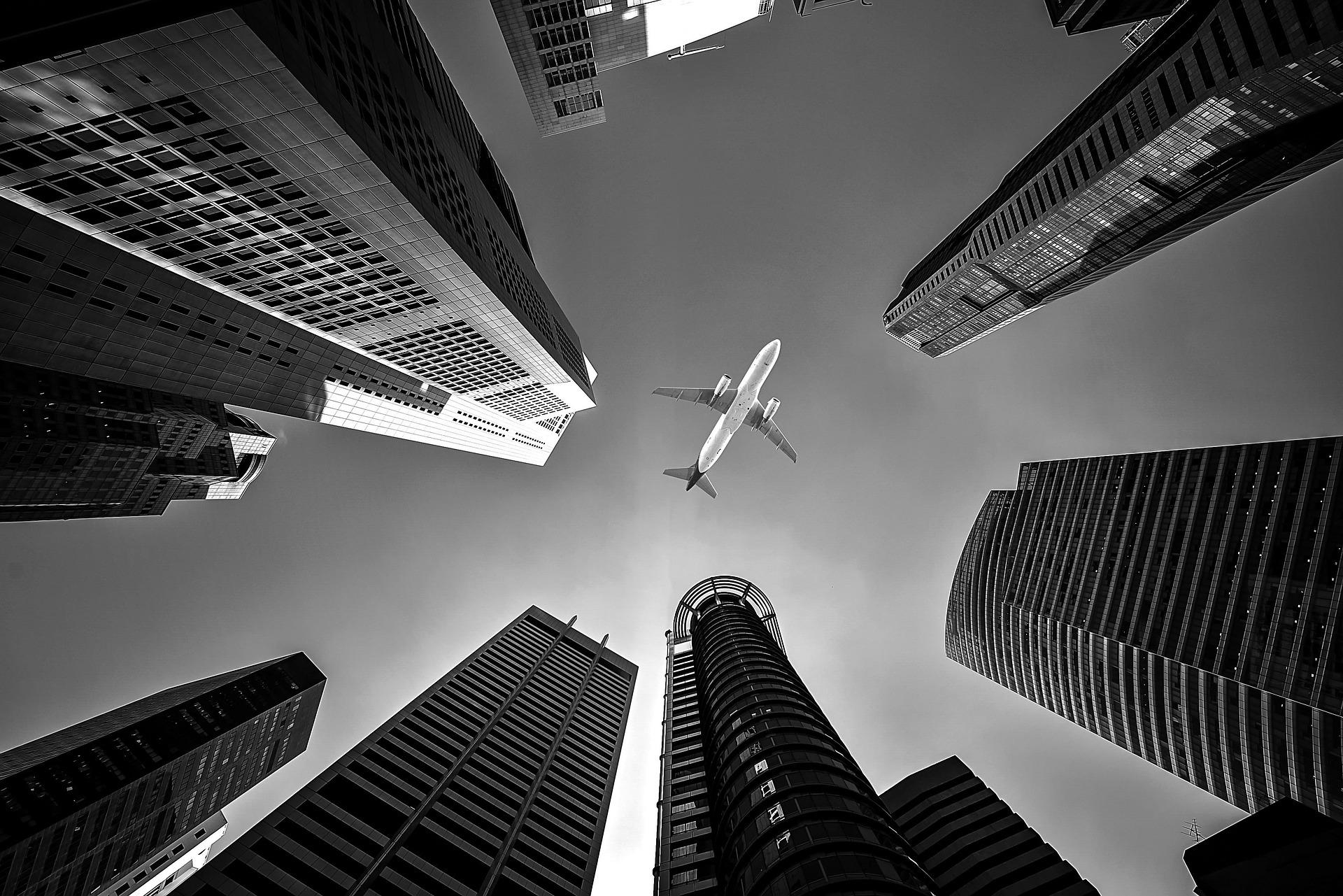 Modern skyscrapers with airplane