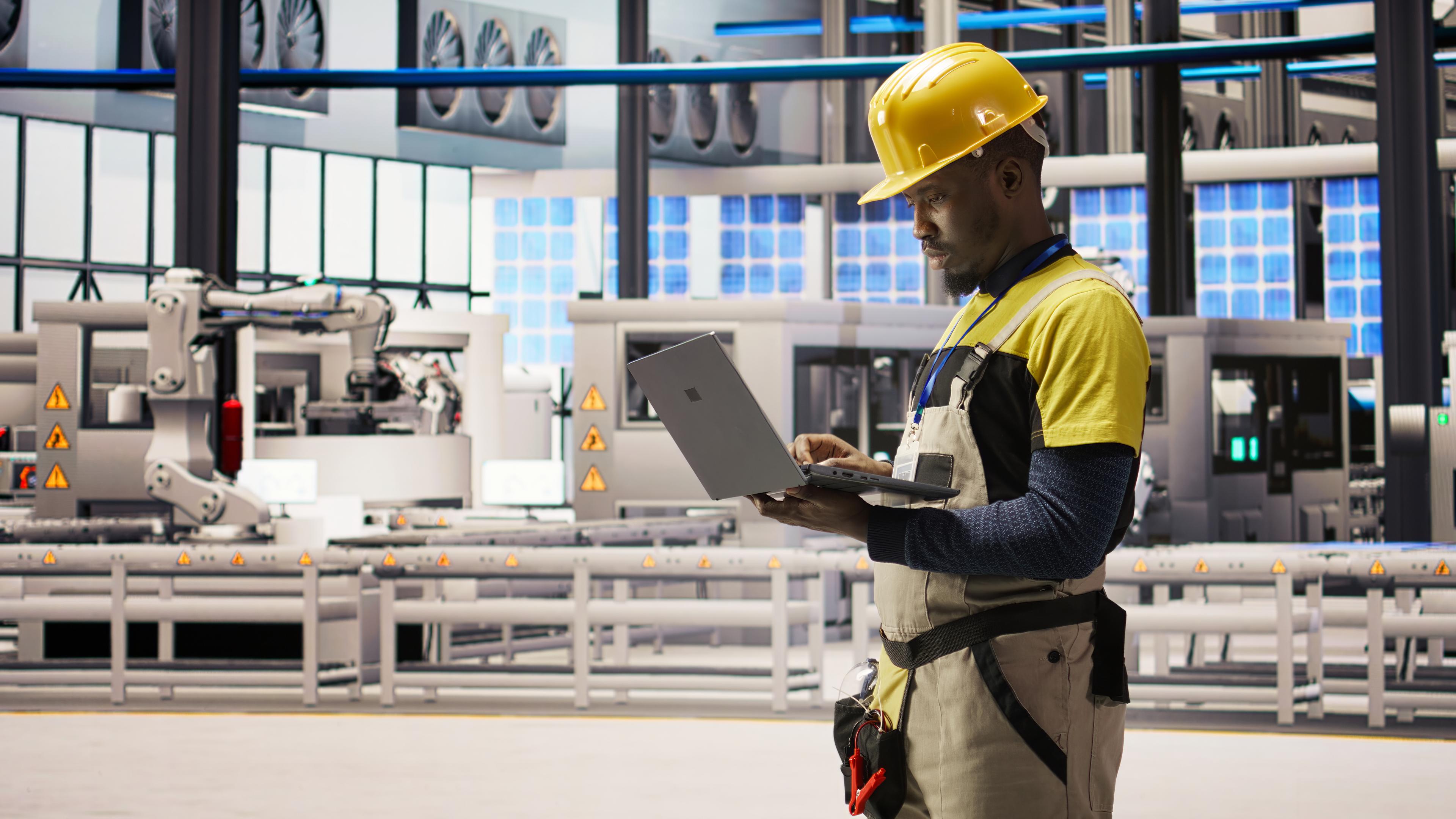 Worker with tablet at industrial site
